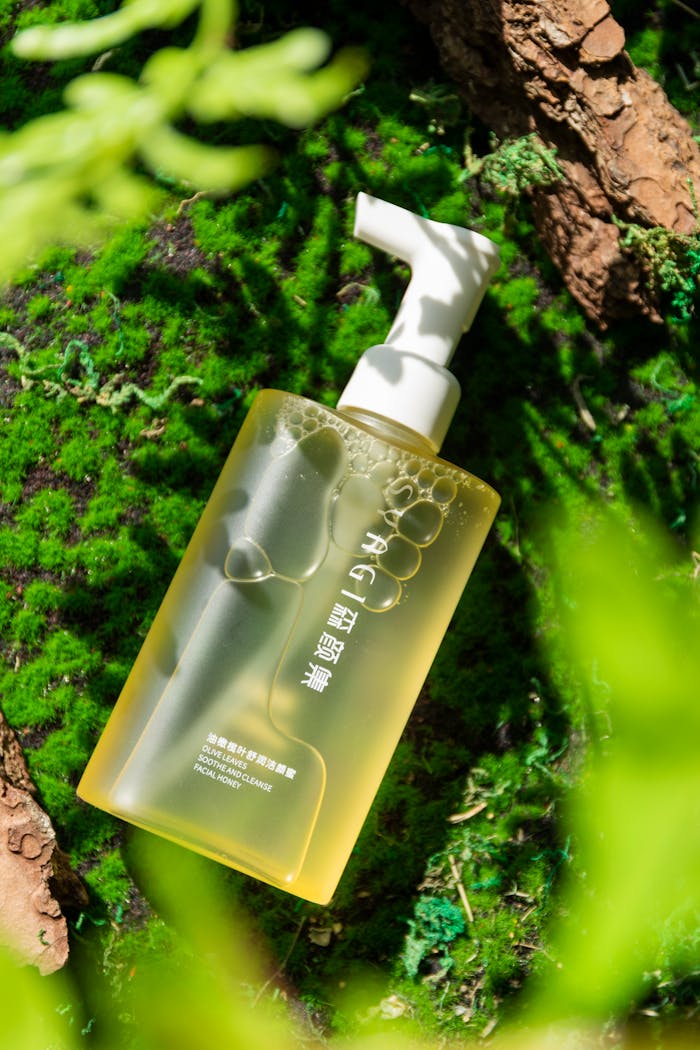 services-03 A skincare bottle with pump placed on lush moss, conveying purity and nature.