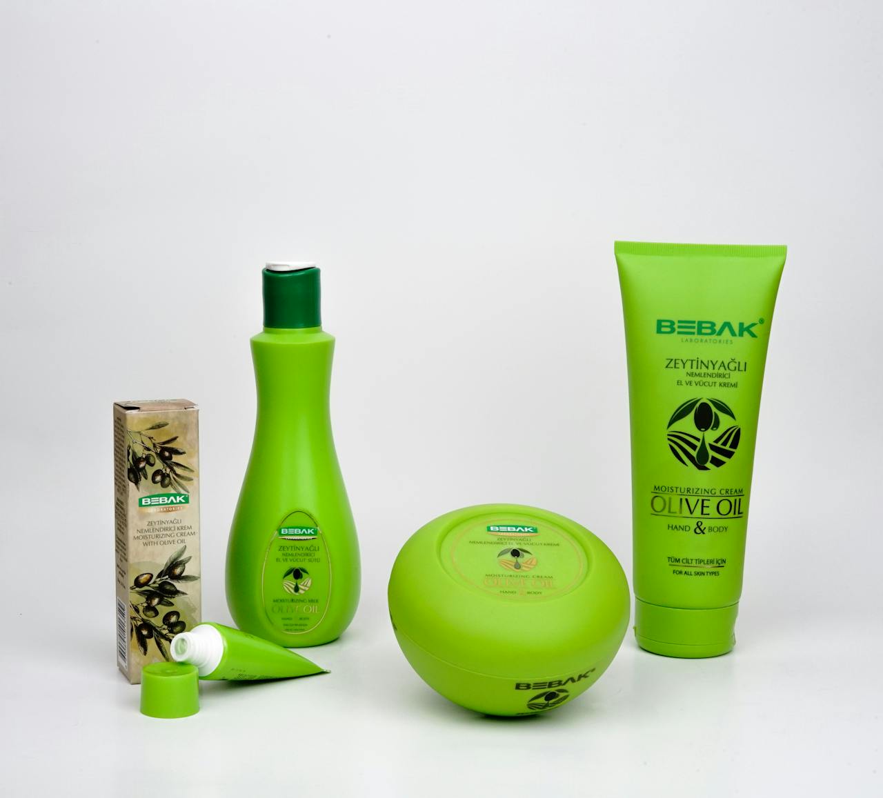 why-choose-us Elegant arrangement of Bebak olive oil skincare products for promotional use.