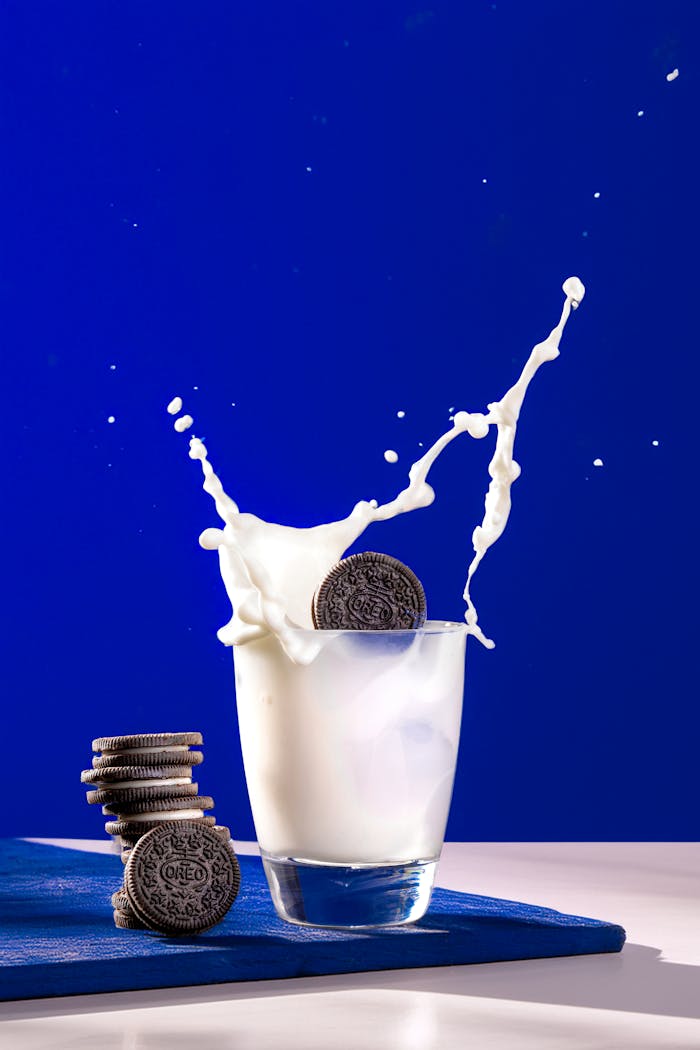 services-01 Dynamic photo of milk splashing with cookies, creating an eye-catching and vibrant scene.